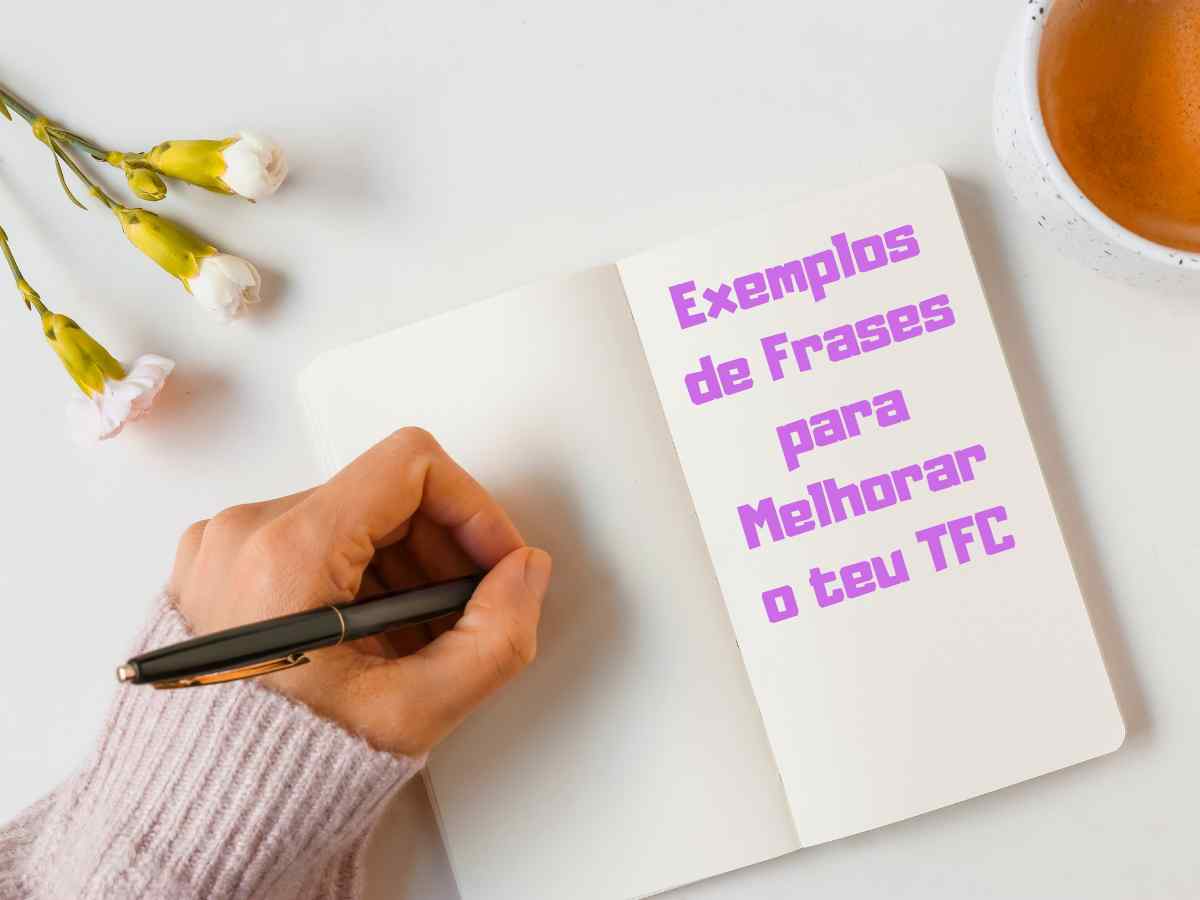 Mão a escrever numa agenda com flores e uma chávena de chá.